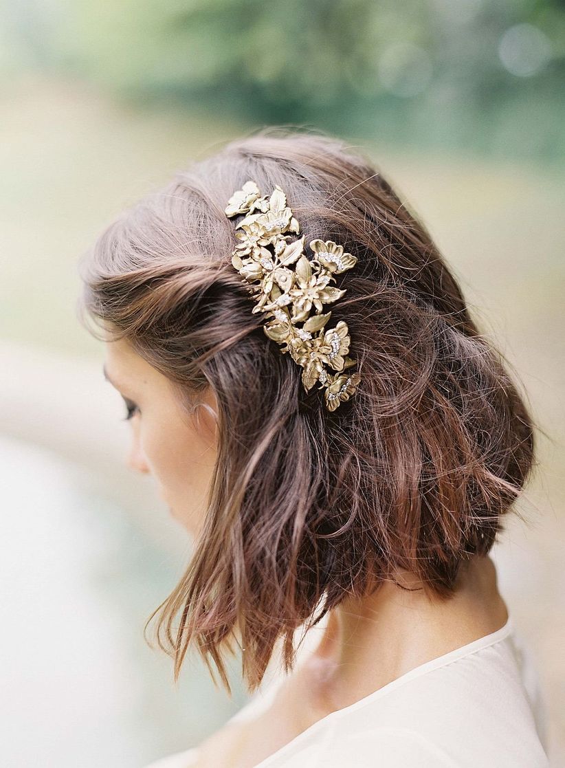 bride with pulled back hairstyle in gold barrette