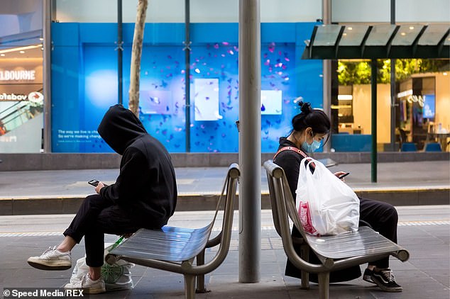 Victorian Premier Daniel Andrews announced the retail sector along with some manufacturing and administration will shut down but supermarkets, groceries and post offices will stay open. Pictured are commuters wearing facemasks in Melbourne