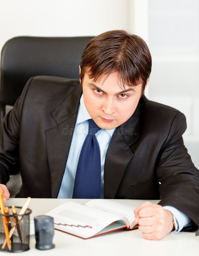 Angry modern businessman banging fist on table. Angry modern business man banging fist on table stock images