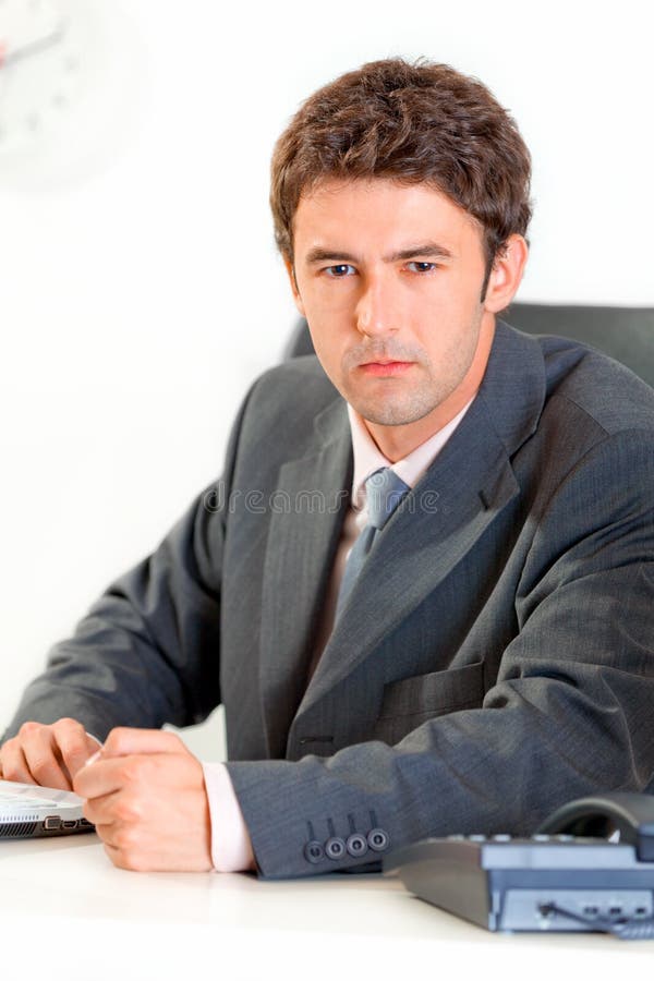 Angry modern businessman banging fist on table. Angry modern business man banging fist on table stock image
