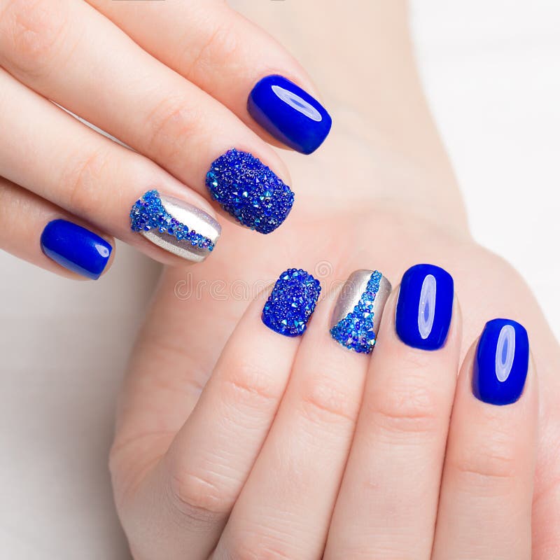 Beautifil blue manicure with rhinestone. Nail Design. Close-up royalty free stock image