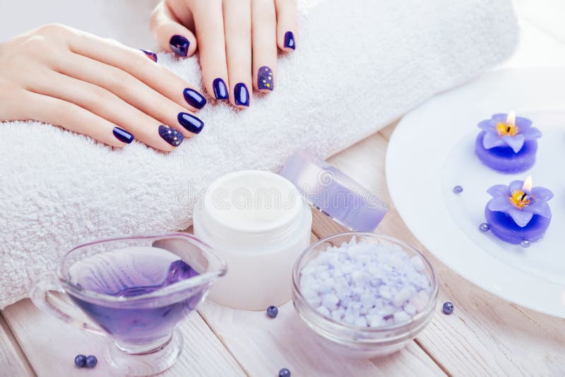 Beautiful blue manicure with spa essentials royalty free stock photos