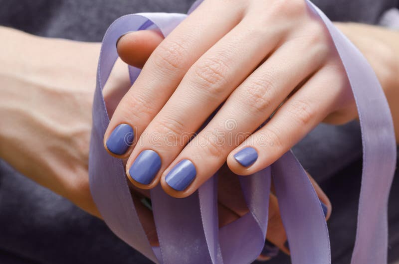 Beautiful female hand with purple nail design stock image