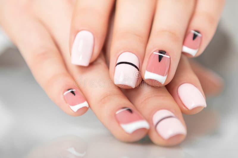 Beautiful female hands with a fashionable manicure. Geometric design of nails royalty free stock images