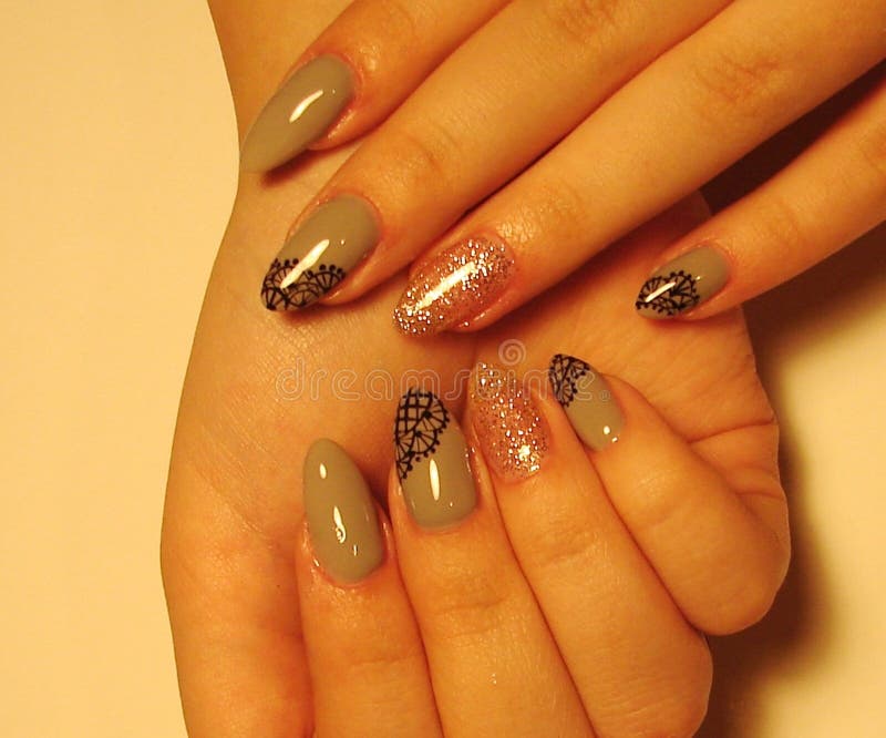 Beautiful gray manicure with design on long nails. royalty free stock images