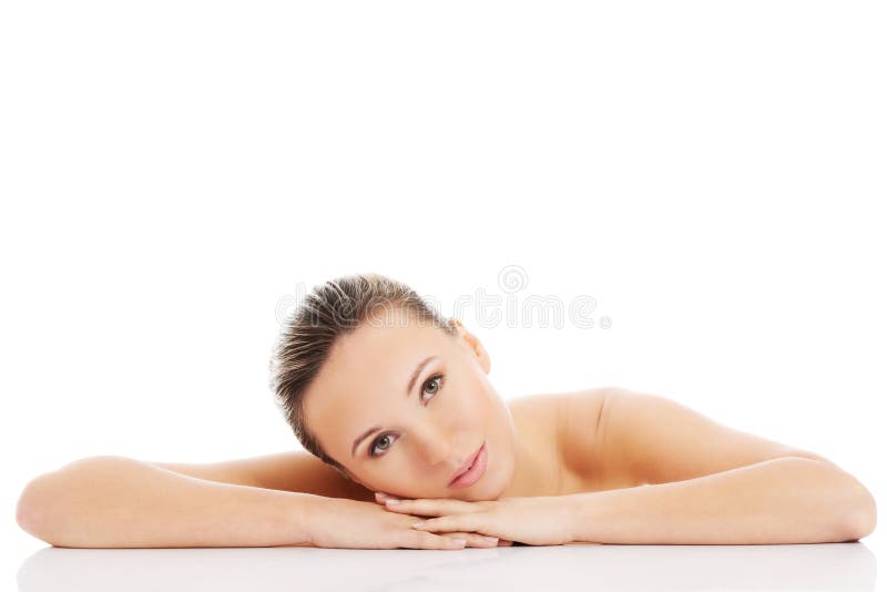 Beautiful nude woman is lying on her hands. stock image