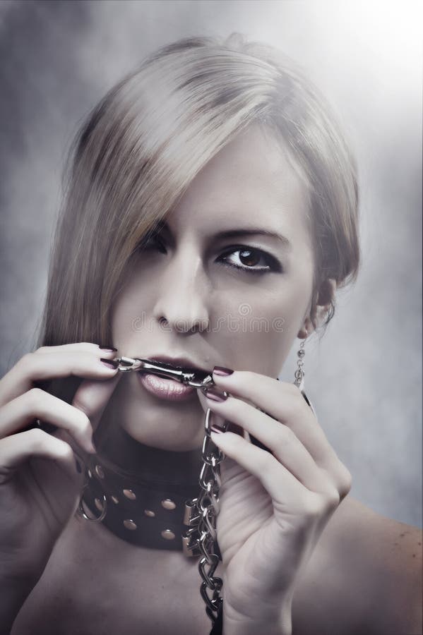 Beautiful Woman with chain in her mouth royalty free stock images