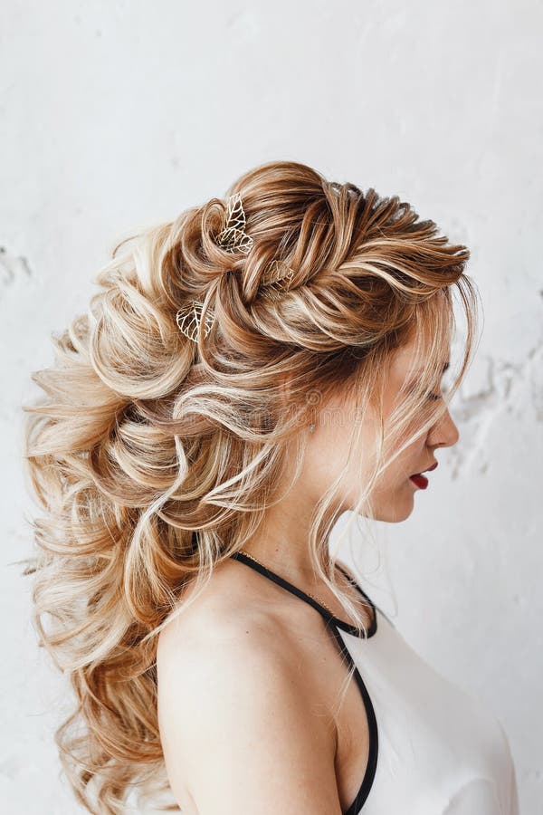 Woman with dyed hair with Evening hairstyle Greek braid stock image