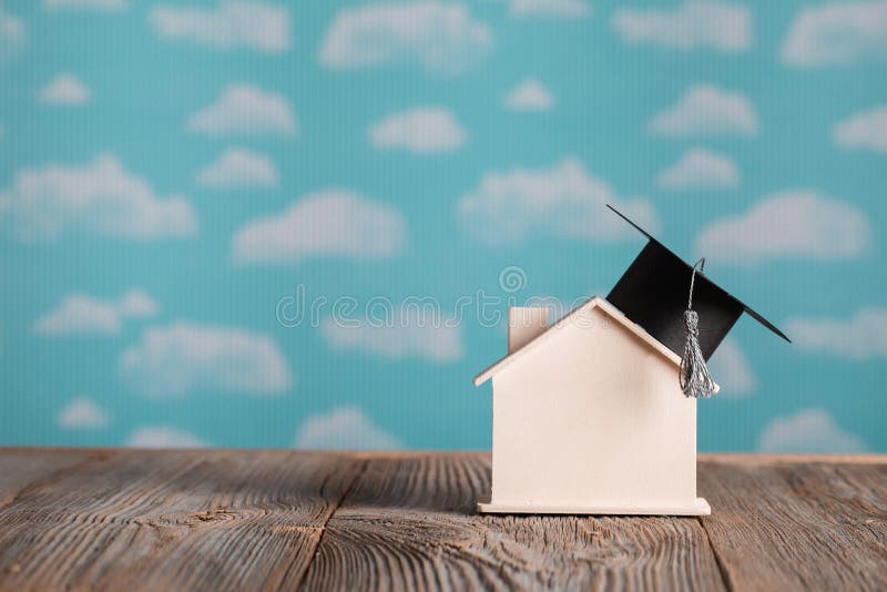 Black square academic cap on a handmade small house., Academic h royalty free stock photos
