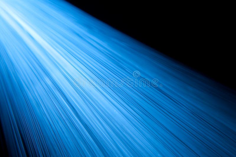 Blue fibre optic strands. A close up abstract-style shot of many illuminated fibre optic light strands giving off a blue and white light stock images