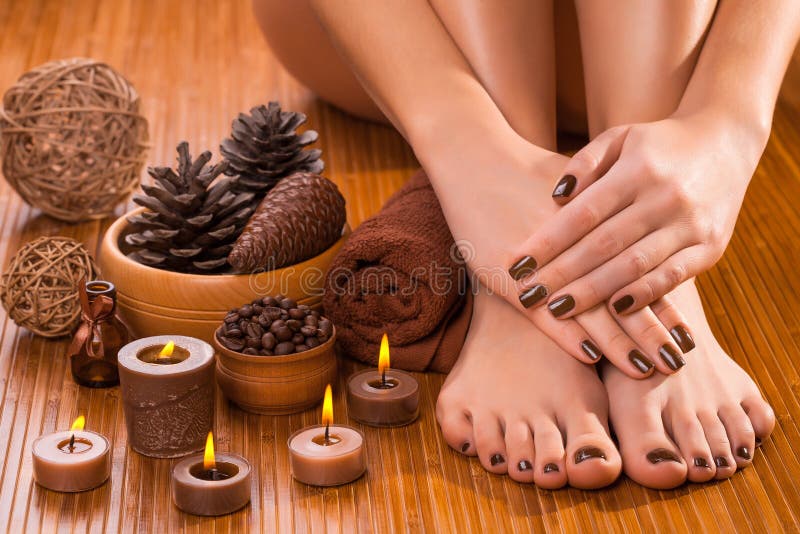 Brown manicure and pedicure on the white stock photography