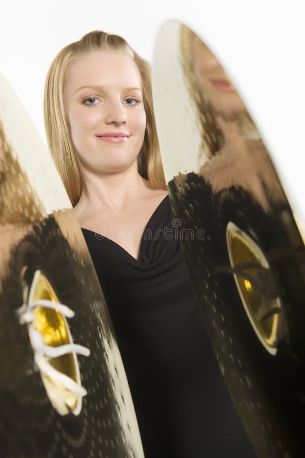 Caucasian Woman Banging Cymbals. Beautiful Caucasian woman banging cymbals isolated over white background stock photo