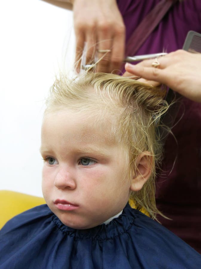 Child getting haircut. Portrait of child getting haircut stock photography