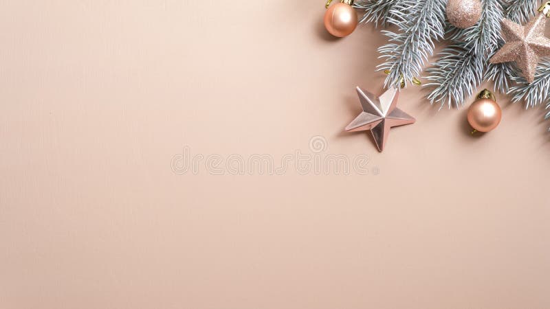 Christmas tree branch with cream color balls and stars on copper background. Flat lay, top view, copy space. Minimal style Xmas. Composition. Christmas party royalty free stock image