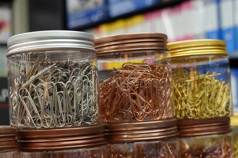 Close up Picture of gold color and copper color paperclips in the bottle. Picture of gold color and copper color and silver color paperclips in the bottle stock photography