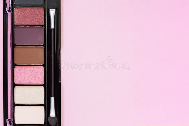 Colorful Eye Shadow Palette Makeup Products on pastel pink background with copy space. royalty free stock photo