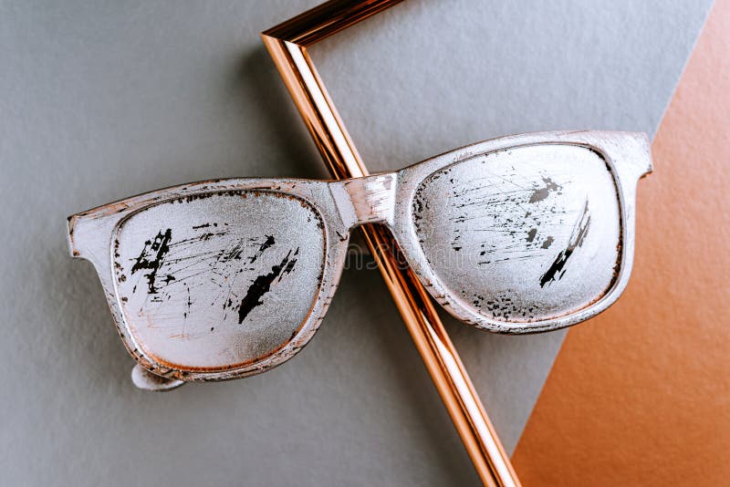 Creative layout Summer glasses silver color with scratches on a gray copper paper geometric background with a metal gold frame. Creative layout with Summer royalty free stock image