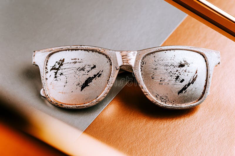 Creative layout Summer glasses silver color with scratches on a gray copper paper geometric background with a metal gold frame. Creative layout with Summer stock images