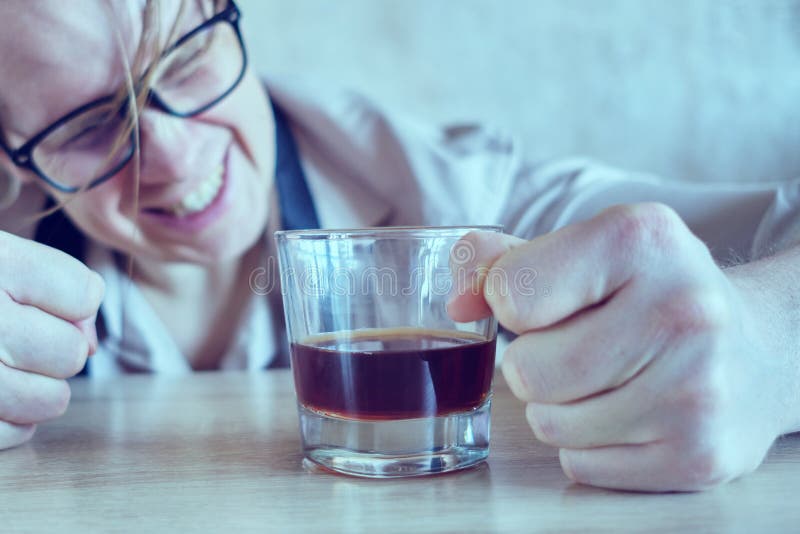 A drunk man in a shirt and tie is banging his fist on the table. Toned. Close up stock image
