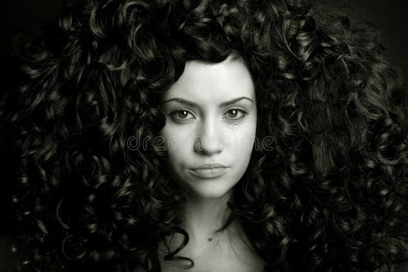 Elegant girl with curly hair. Elegant girl with magnificent curly hair. Studio portrait stock photos