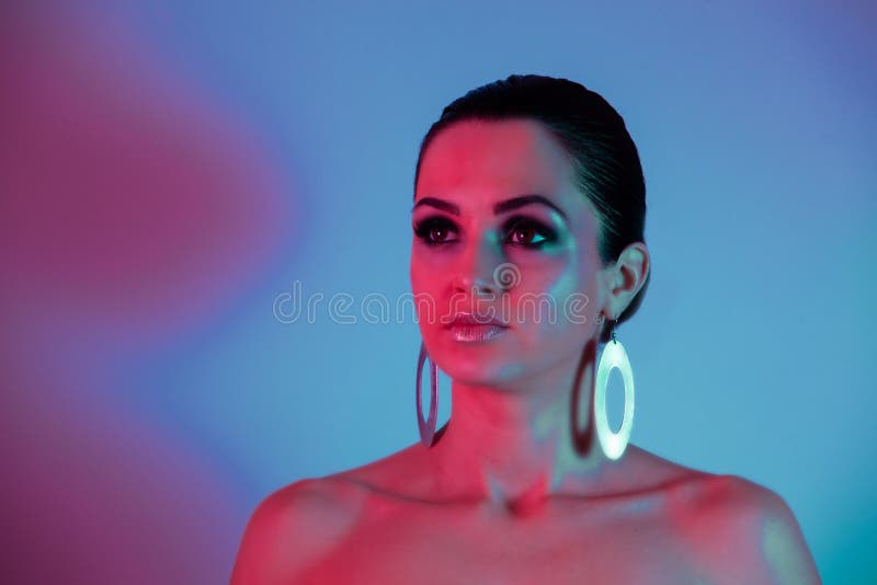 Fashion model under the neon pink and blue light stock photography