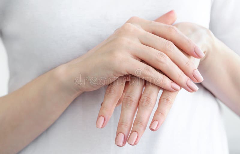 Female hands with gently beige manicure. Hand skin care. royalty free stock photos