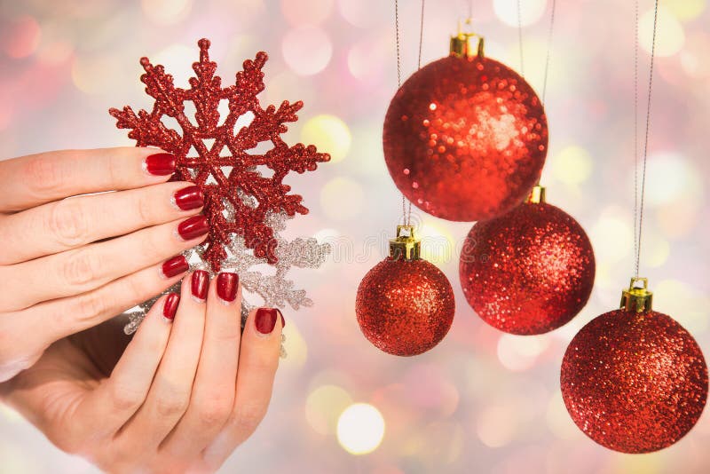 Female hands with professional holiday red and silver manicure royalty free stock photo