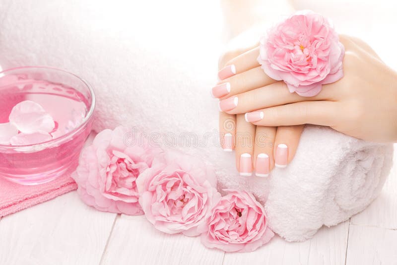 French manicure with rose flowers. spa royalty free stock image