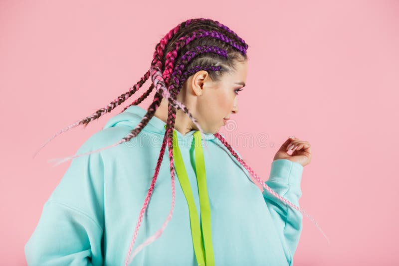 A girl with a fashionable set of multicolored braids Kanekalon. Colored artificial strands of hair.  stock image