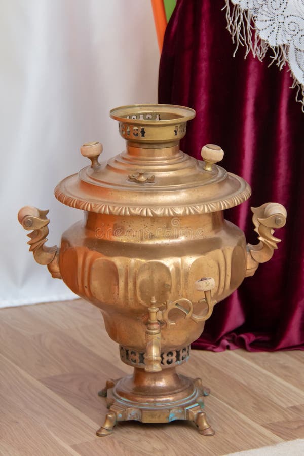 Gold color Metal samovar on a background . Samovars are typically crafted out of plain iron, copper, polished brass. Samovars are typically crafted out of plain stock photo