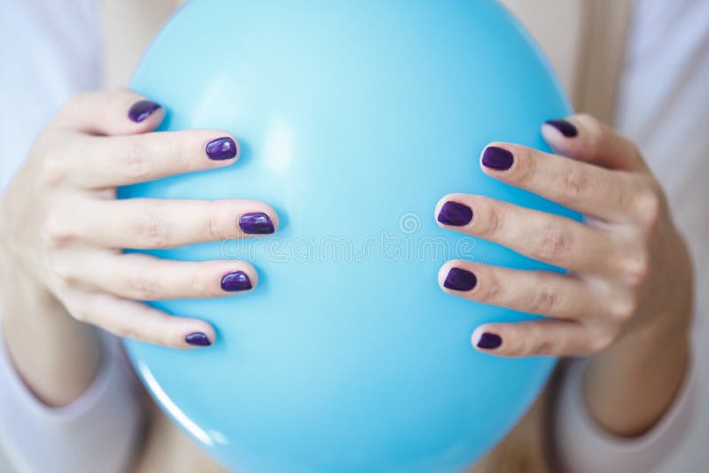 Gorgeous manicure, dark purple tender color nail polish, closeup photo. Female hands over simple background stock photos