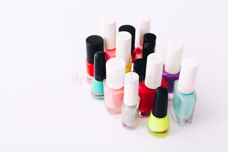 Group of nail polishes of different colors on white background royalty free stock photography