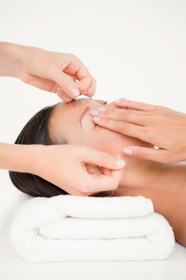 Hands threading beautiful womans eyebrow. Close up view of hands threading beautiful womans eyebrow royalty free stock photos