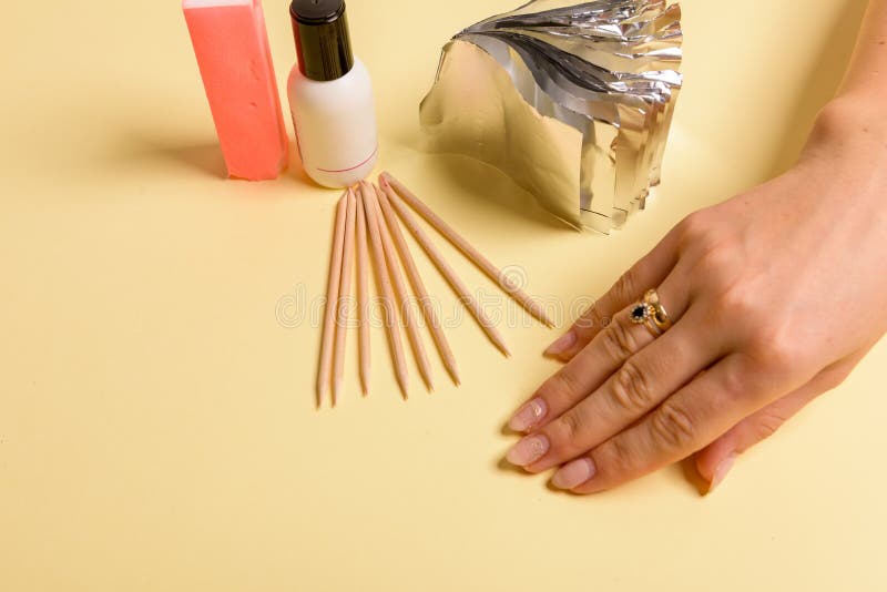 Hybrid manicure removal kit. The procedure for removing varnish from nails in progress royalty free stock image