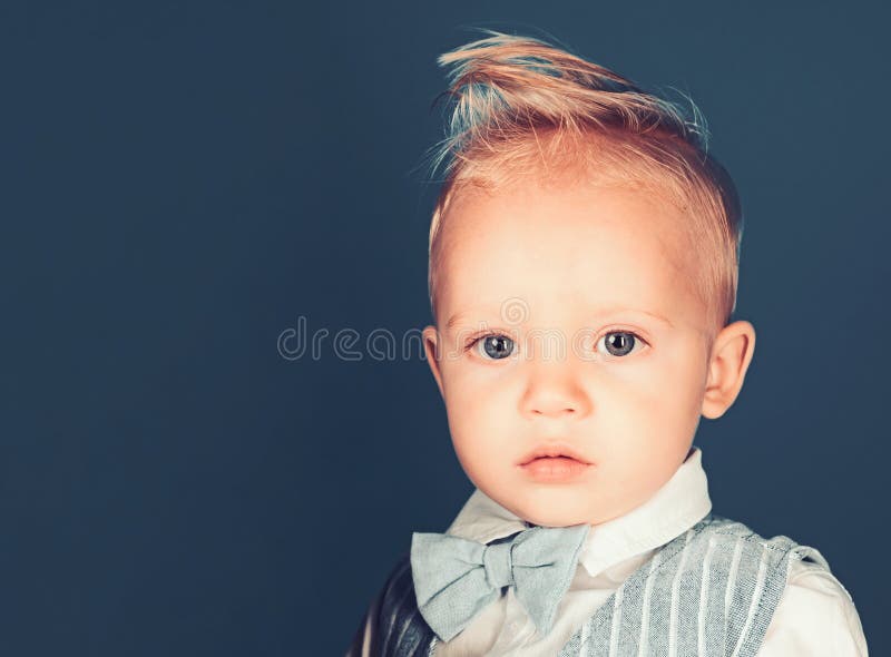 I care about my hair. Small child with messy top haircut. Small boy with stylish haircut. Boy child with stylish blond. Hair. Healthy hair care habits. Hair stock photo