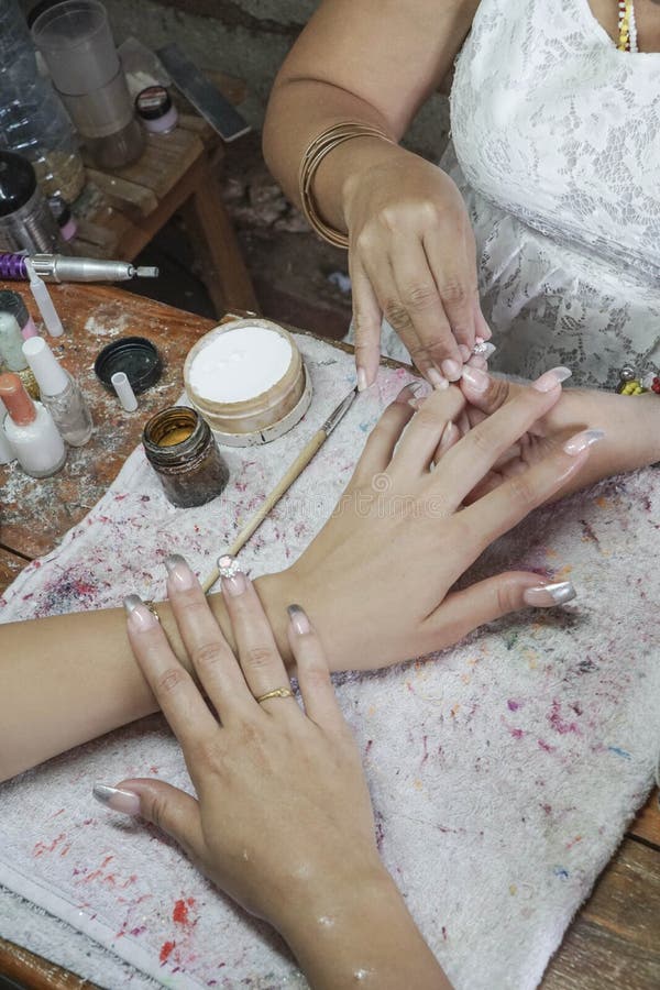 Manicure process in a beauty salon showing making of artificial nails stock photo