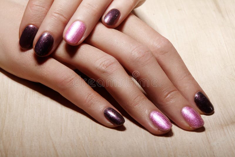 Manicured nails with shiny nail polish. Manicure with bright nailpolish. Fashion art manicure with shiny gel lacquer stock photos