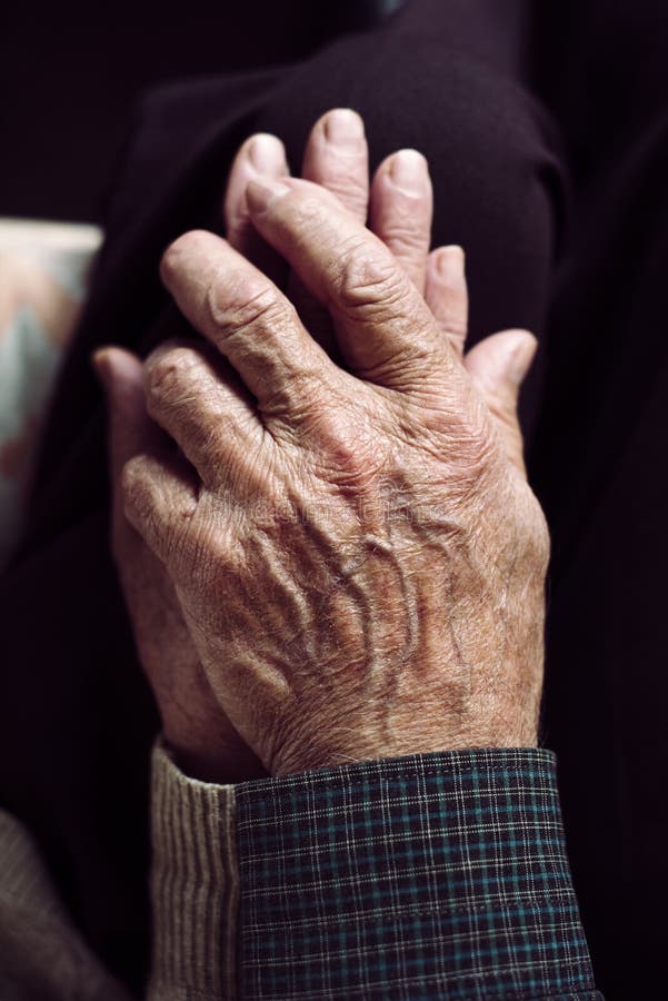 Old man and old woman holding hands royalty free stock photo