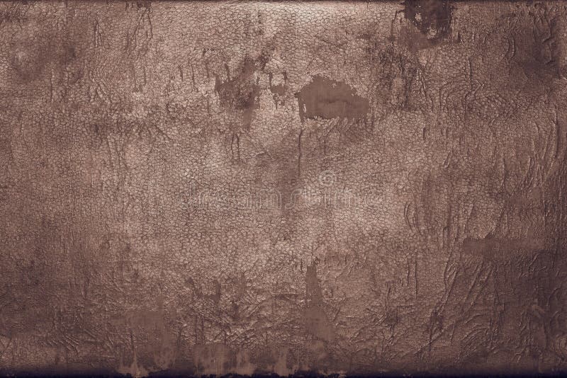 Old shabby skin of dark copper color with gloss. The abstract textured background of rough shabby and frayed old leather of dark copper color with gloss stock images