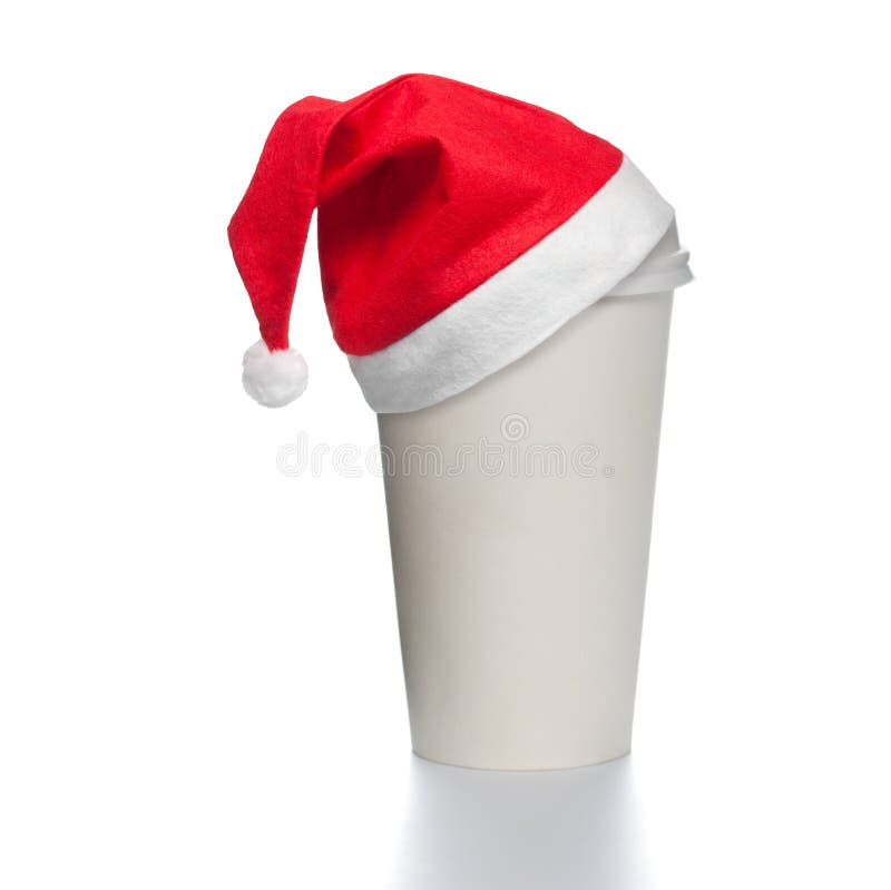 Paper coffee cup with santa hat. White paper coffee cup with plastic cap on top. Blank space for copy on cup and besides. Red santa christmas hat on top of the royalty free stock photos