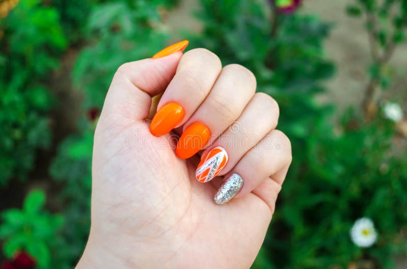 Perfect manicure and natural nails. Attractive modern nail art design. orange autumn design. long well-groomed nails stock photo