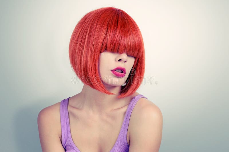 Portrait young woman with red hair and bang covering her eyes.  stock photo