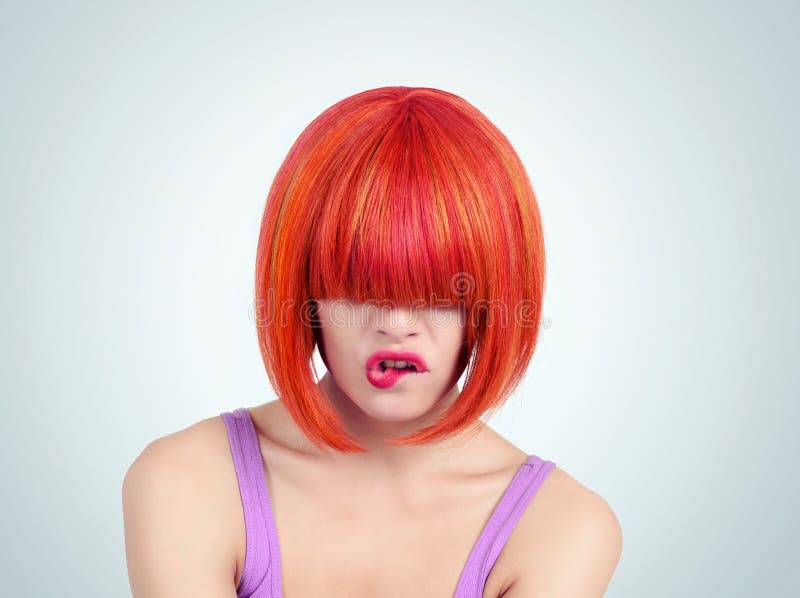 Portrait young woman with red hair and bang covering her eyes. On background royalty free stock photo