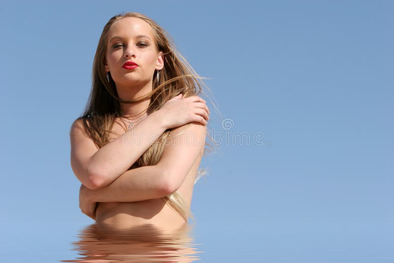 Pretty blond woman. In water stock photo