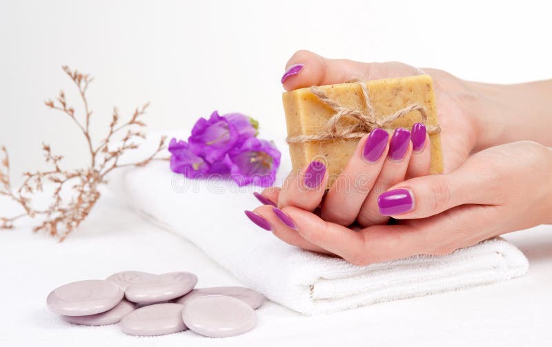 Purple manicure and herbal soap royalty free stock photo