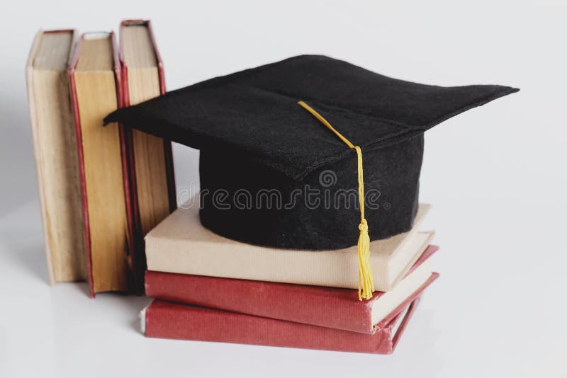 Square academic hat. Graduation. Square academic hat with books stock photography