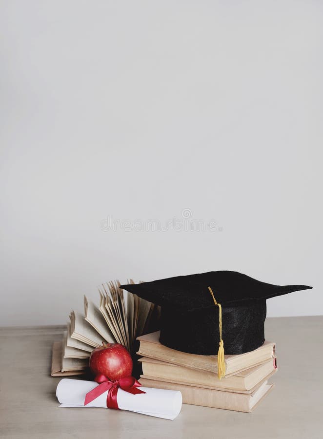 Square academic hat. Graduation. Square academic hat with books stock photo
