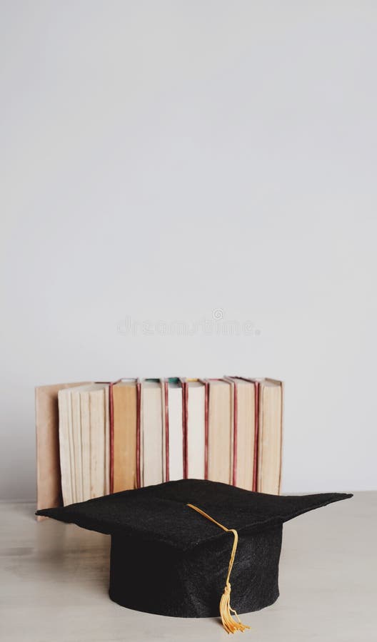 Square academic hat. Graduation. Square academic hat with books royalty free stock photo