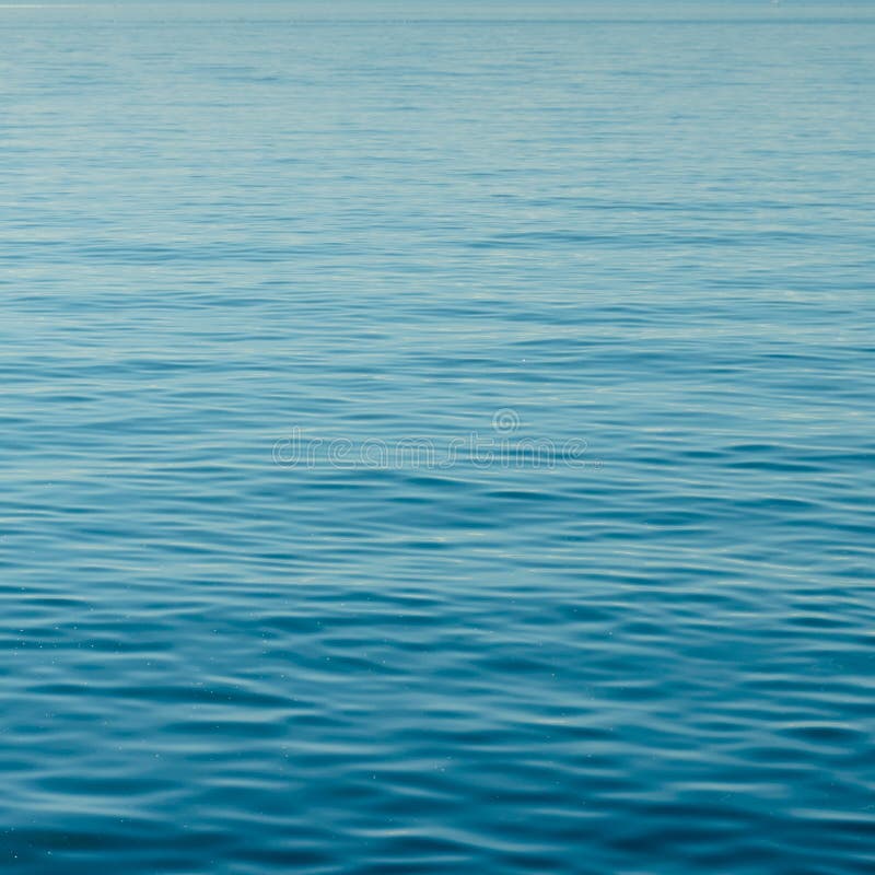 Background of calm blue water with small waves and endless ripples. Square format background of calm blue water with small waves and endless ripples and copy royalty free stock photography