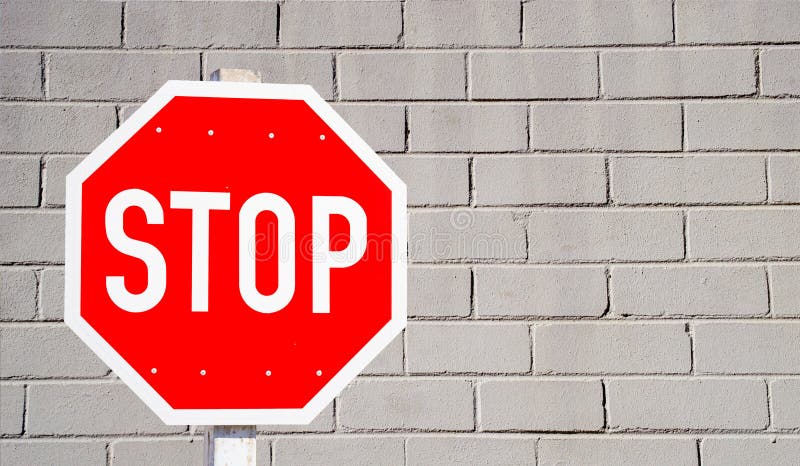 Stop Sign and Wall. Stop banging your head against a brick wall stock photo